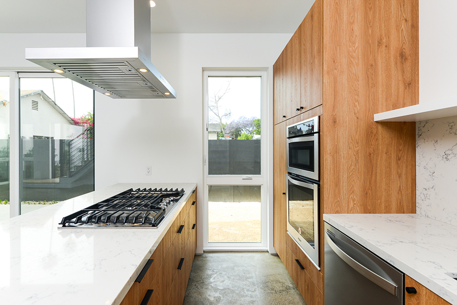 Interior render of Split Shift kitchen, emphasizing modern residential design with natural light and warm material finishes.